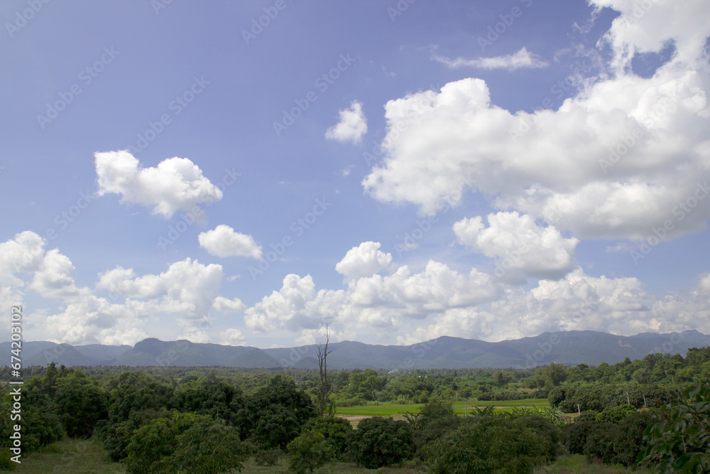 Blue sky with clouds and mountains natural green trees