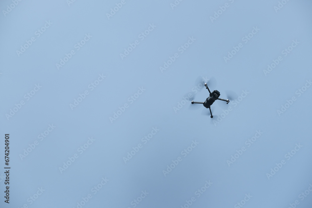 a mini drone flying in the sky a mini drone flying in the sky