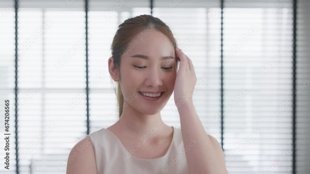 Portrait of attractive young Asian businesswoman smiling standing in office near window. Beautiful woman confident. Emotions happy. business worker Portrait of attractive young Asian businesswoman smiling standing in office near window. Beautiful woman confident. Emotions happy. business worker