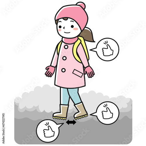 雪道を転ばないように歩く女性