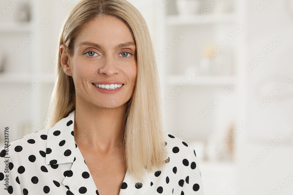 Portrait of beautiful woman in stylish clothes indoors. Space for text. Confident lady with blonde hair looking into camera Portrait of beautiful woman in stylish clothes indoors. Space for text. Confident lady with blonde hair looking into camera