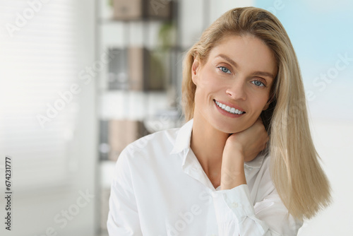 Portrait of beautiful woman in formal clothes indoors. Space for text. Confident lady with blonde hair looking into camera Free Download Portrait of beautiful woman in formal clothes indoors. Space for text. Confident lady with blonde hair looking into camera - GFXLoad