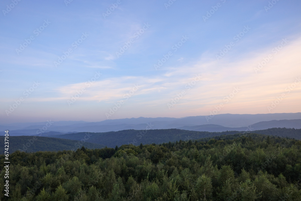 Picturesque view of mountains covered with forest under sky