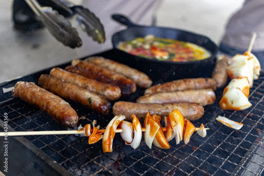 Grilling sausages and vegetables - outdoor cooking - summer BBQ