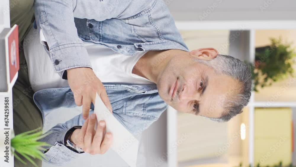 Vertical video of The man who loves the photo in his hand. Vertical video of The man who loves the photo in his hand.