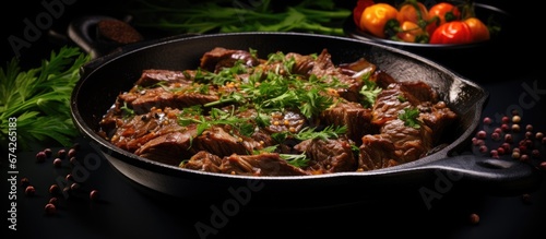 Sliced beef accompanied by a side dish and sauce presented on a portioned skillet garnished with parsley Captured up close against a dark backdrop