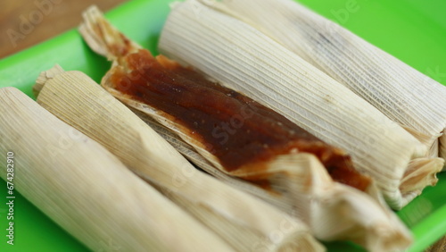 Dodol Garut wrapped in corn husks.. Made of sticky rice flour, palm sugar, coconut milk and grated coconut. Originally from garut, West Java, Indonesia. photo