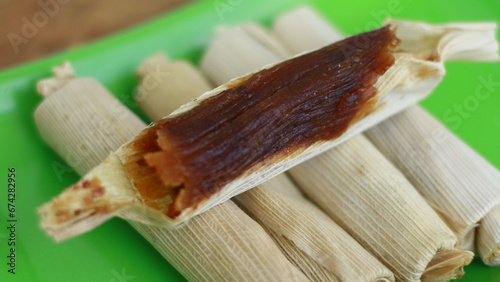 Dodol Garut wrapped in corn husks.. Made of sticky rice flour, palm sugar, coconut milk and grated coconut. Originally from garut, West Java, Indonesia. photo