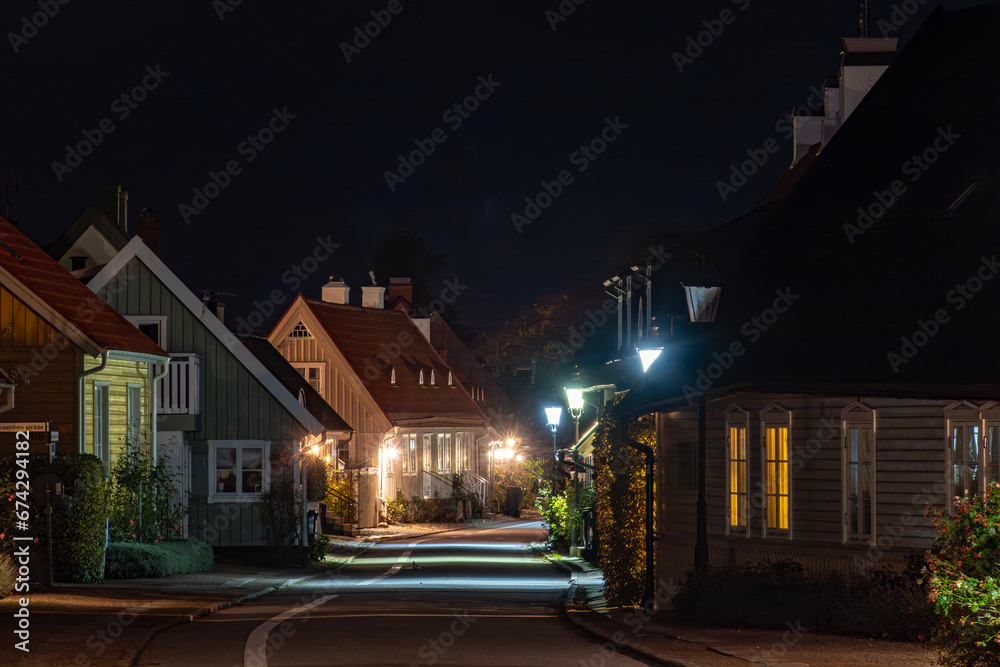Bastad, Sweden Small cottages  at night on the landmark and picturesque Agardhsgatan and street lamps. .