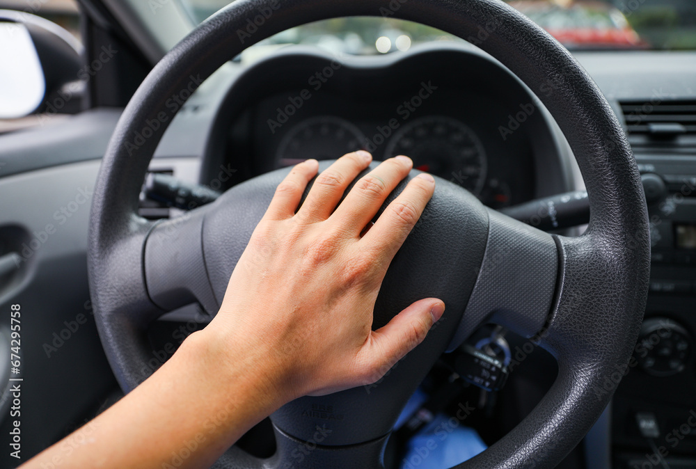 hands gripping a steering wheel, symbolizing control, focus, and safety while driving