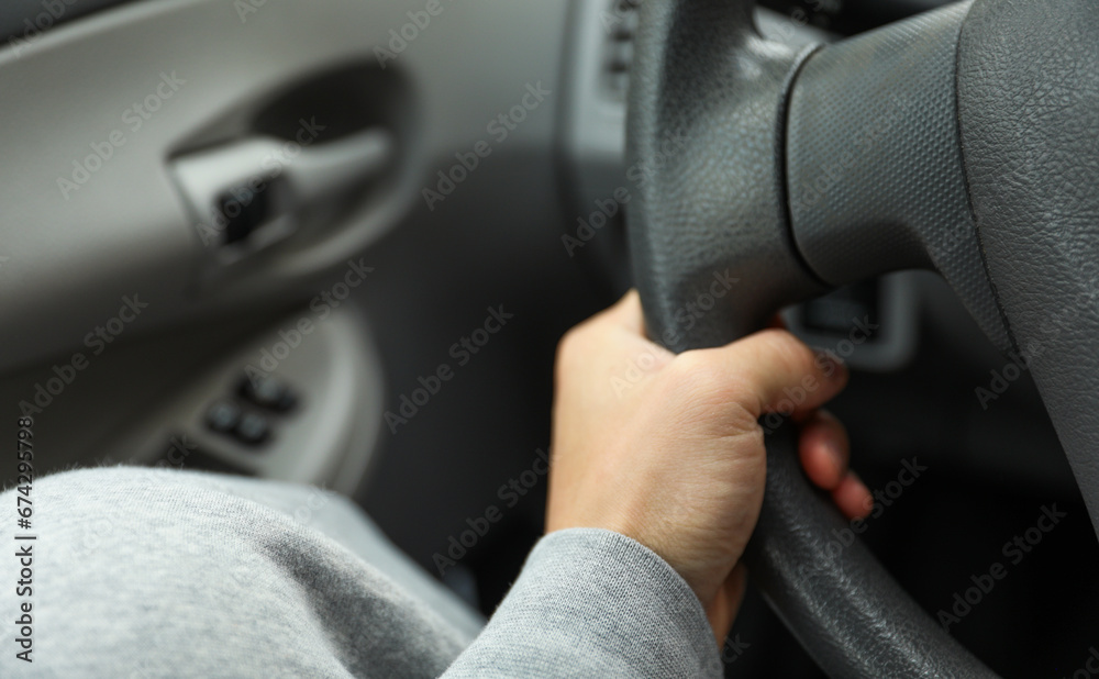 hands gripping a steering wheel, symbolizing control, focus, and safety while driving