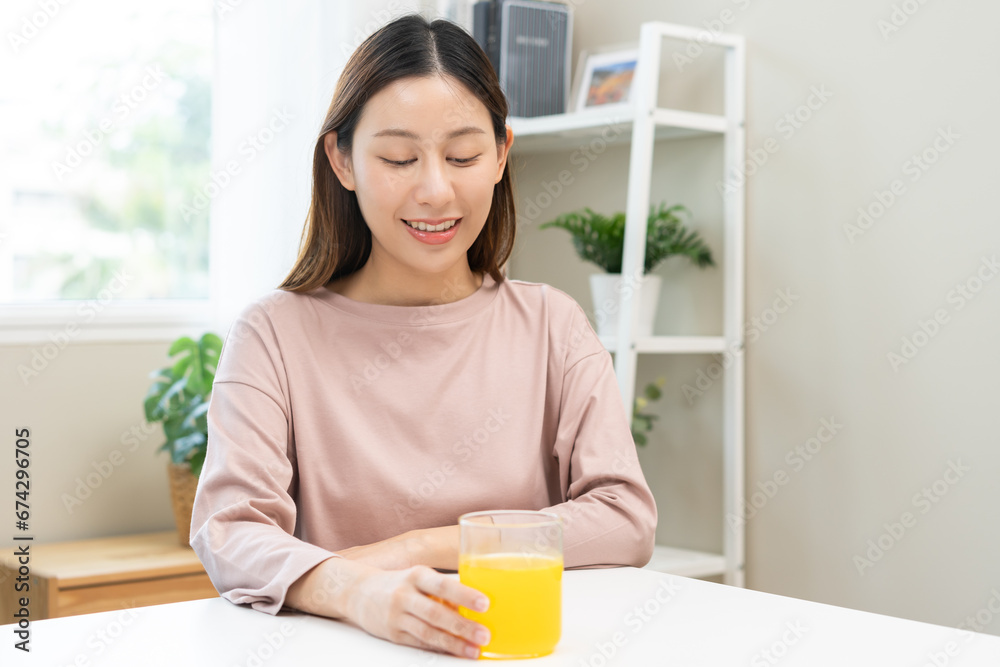 Asian young woman holding glass of water after putting or dropping yellow effervescent tablet, pain pill, painkiller medicine, aspirin for treatment, take vitamin c for hangover. Health care concept. Asian young woman holding glass of water after putting or dropping yellow effervescent tablet, pain pill, painkiller medicine, aspirin for treatment, take vitamin c for hangover. Health care concept.