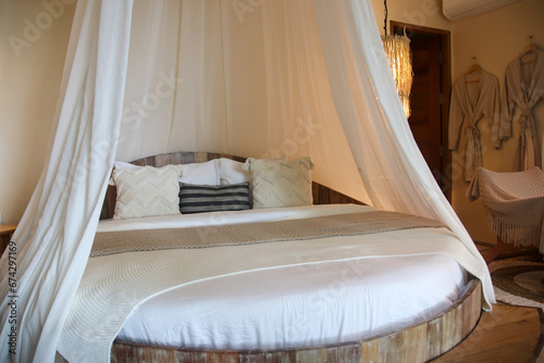 фотографія Interior of stylish room with comfortable round bed and canopy