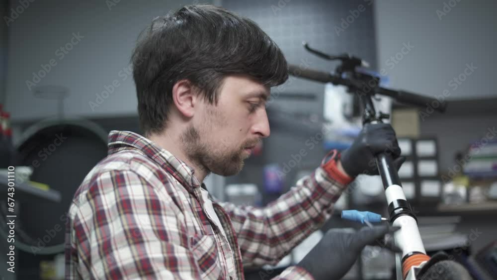 Professional craftsman working on electric scooter in workshop. Technicians fixing wheel from kids push scooter in repair shop. Mechanic at work. Eco-friendly transport. Scooter maintenance service. Professional craftsman working on electric scooter in workshop. Technicians fixing wheel from kids push scooter in repair shop. Mechanic at work. Eco-friendly transport. Scooter maintenance service.