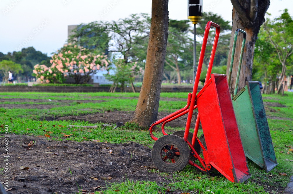 Fototapeta premium Garden wheelbarrows are parked . These handcart are been ready for farm gardening because they are a tool for carriage a cargoes.