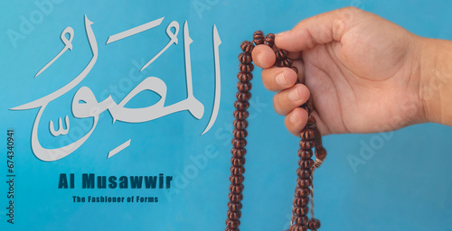 Hand of Muslim woman holding prayer beads, 99 Names of God, Muslim woman praying Name Of Allah Al Musawwir photo