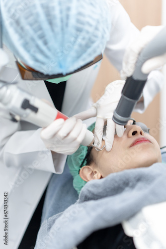 Woman receiving pico laser facial treatment in beauty Clinic.