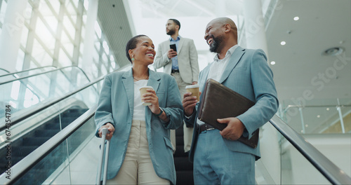 Happy business people, coffee and laughing on escalator for funny joke, discussion or morning at airport. Businessman and woman smile with latte or cappuccino down a moving staircase for work travel