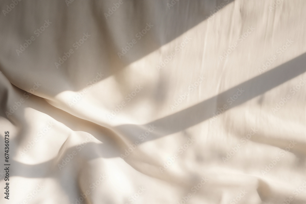 Beige satin fabric texture background with sunlight and shadow from window. High quality photo - obrazy, fototapety, plakaty 