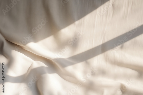 Beige satin fabric texture background with sunlight and shadow from window. High quality photo