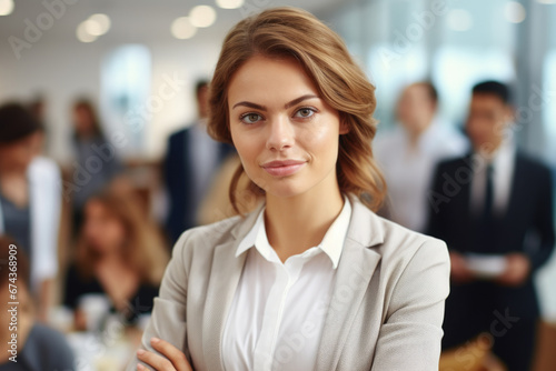 Confident woman standing with her arms crossed in front of group of people. This image can be used to convey leadership, confidence, teamwork, or assertiveness in various professional settings.
