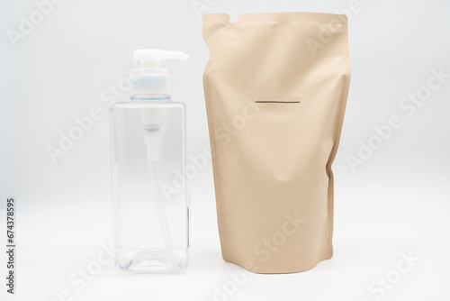 Plastic packaging for refill pouch and Plastic pump bottle in isolated background. Zero waste. Reuse reduce recycle concept. Refillable reusable personalised pump dispenser bottles. photo