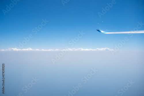 airplane flying over the clouds
