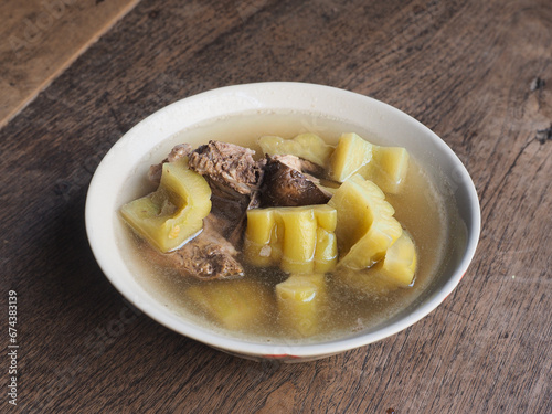 bowl of heathy bitter gourd and pork bone soup photo