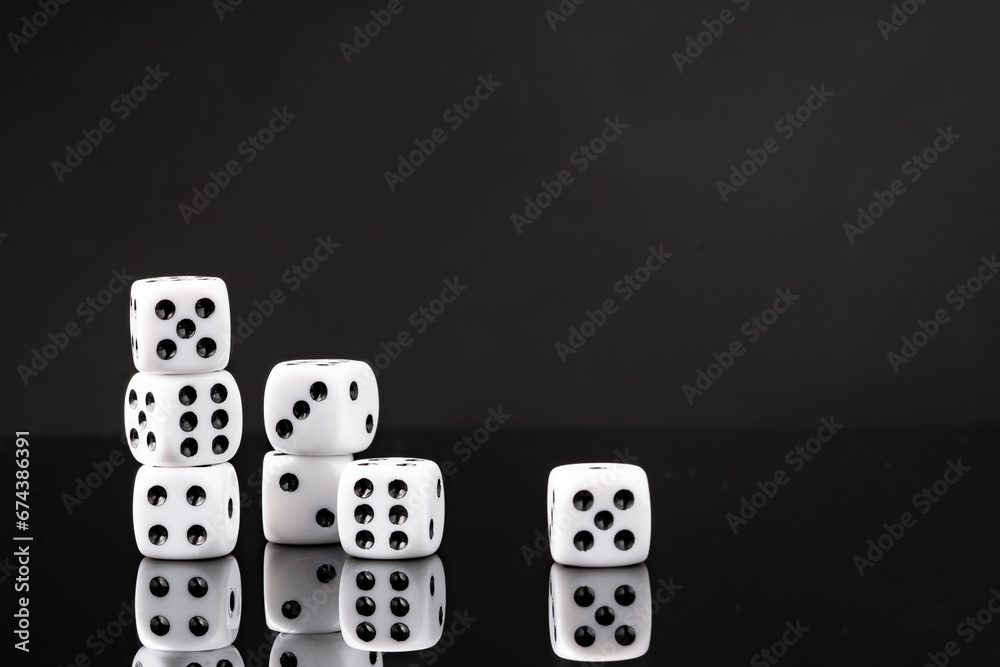 White dice on black background studio shot White dice on black background studio shot