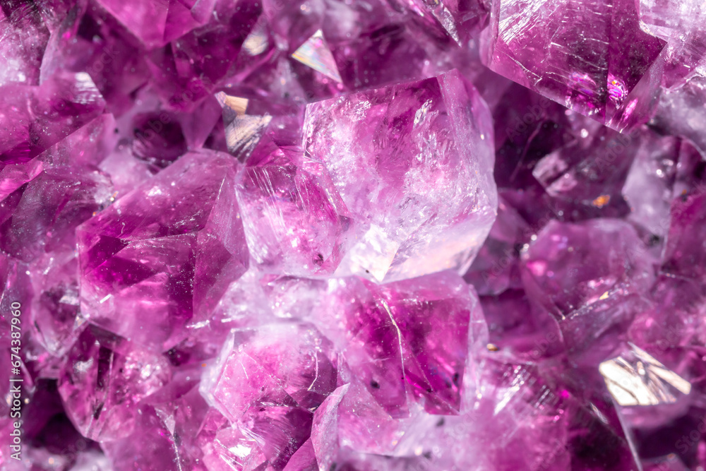 Amethyst purple crystals. Gems. Mineral crystals in the natural environment. Texture of precious and semiprecious stones. Seamless background with copy space colored shiny surface of precious stones. Amethyst purple crystals. Gems. Mineral crystals in the natural environment. Texture of precious and semiprecious stones. Seamless background with copy space colored shiny surface of precious stones.