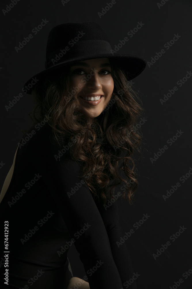 Portrait of an attractive female model in black, solated on a black background. Portrait of an attractive female model in black, solated on a black background.