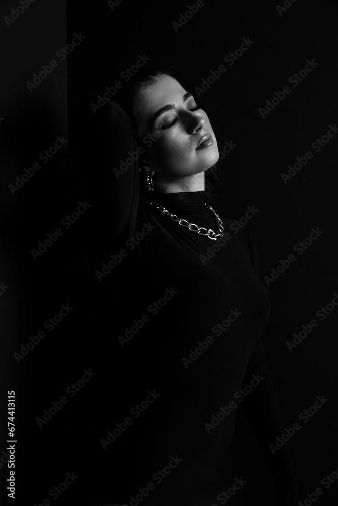 Portrait of an attractive female model in black, solated on a black background. Portrait of an attractive female model in black, solated on a black background.