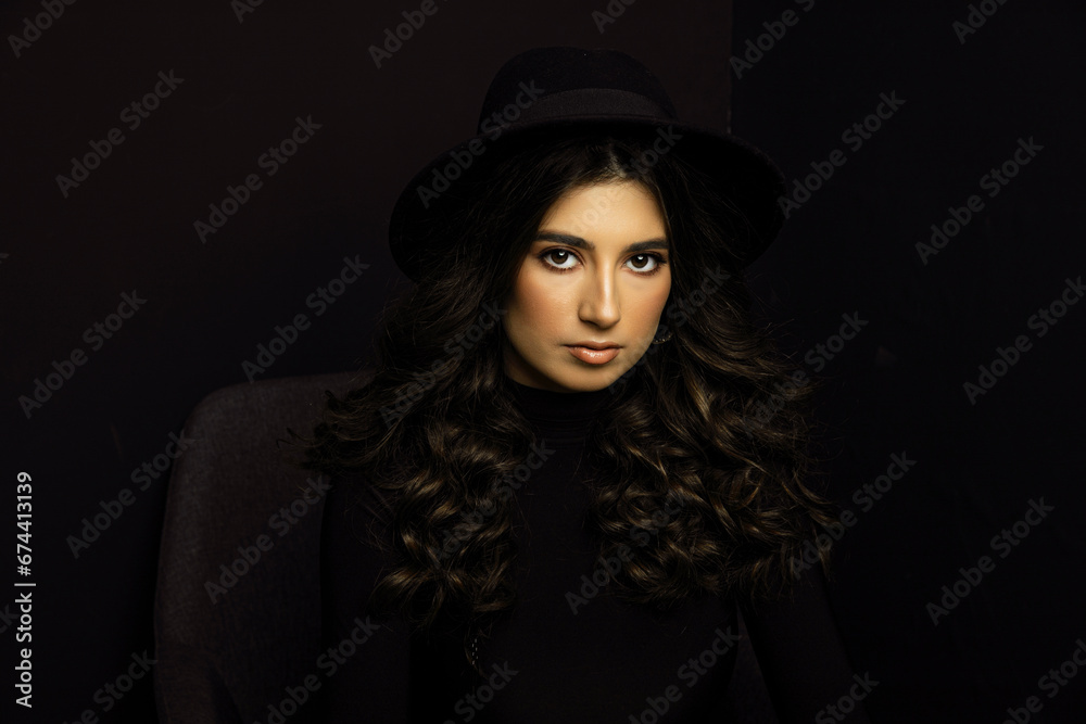 Portrait of an attractive female model in black, solated on a black background. Portrait of an attractive female model in black, solated on a black background.