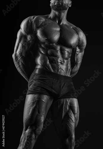 Muscular male torso. Perfect fit, six pack, abs, shoulders, deltoids, biceps, triceps and chest. Black and white image