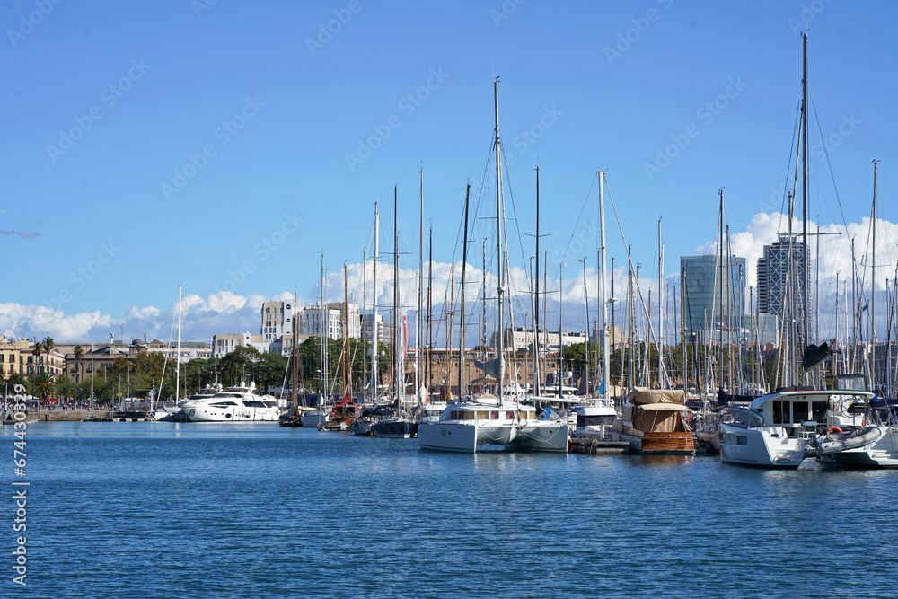 BARCELONA, CATALONIA, SPAIN - October 2023: Port Vell Old Harbor, a waterfront harbor and part of the Port of Barcelona, with yachts and ships