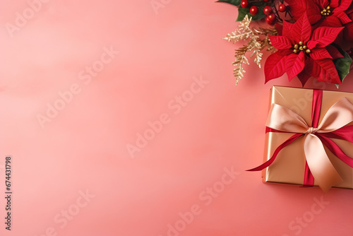 pink christmas background with poinsettia with leaves, red berries, gift box wrapped red silk ribbon, gold tinsel, with empty copy Space