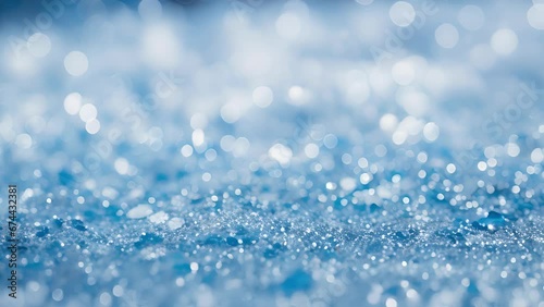 A closeup of an abstract glitter design in varying shades of blue, resembling the tranquility and peace of a snowy winter landscape during the holiday season.