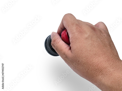 Hand holding red handled round rubber stamp, top view isolated on white