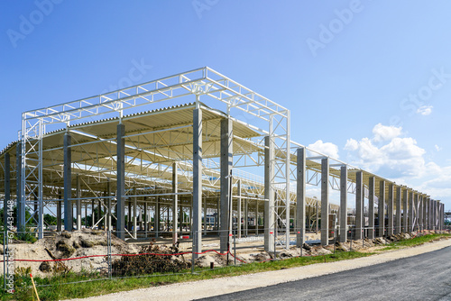 New large building steel framework with corrugated steel roof on reinforced concrete supports photo
