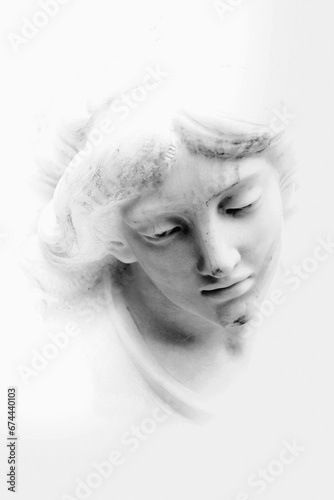 Fototapeta Naklejka Na Ścianę i Meble -  Fragment of ancient statue: face of white beautiful angel. Vertical image.