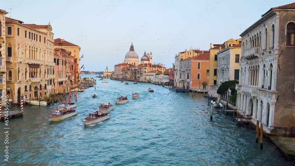 Stunning views of the Venice skyline with the Grand Canal and the Basilica of Santa Maria della Salute in the distance during a spectacular sunset. Stunning views of the Venice skyline with the Grand Canal and the Basilica of Santa Maria della Salute in the distance during a spectacular sunset.