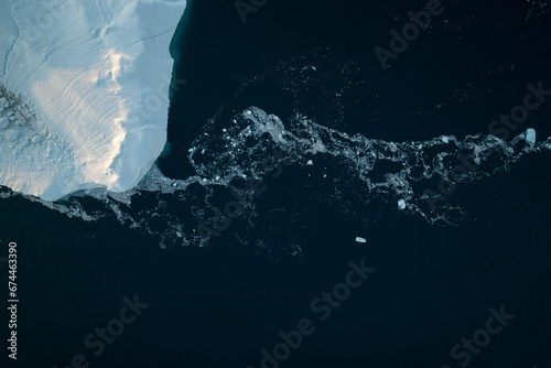 Aerial top-down drone view of an iceberg landscape structure at Ilulissat ice fjord, Greenland, Arctic.