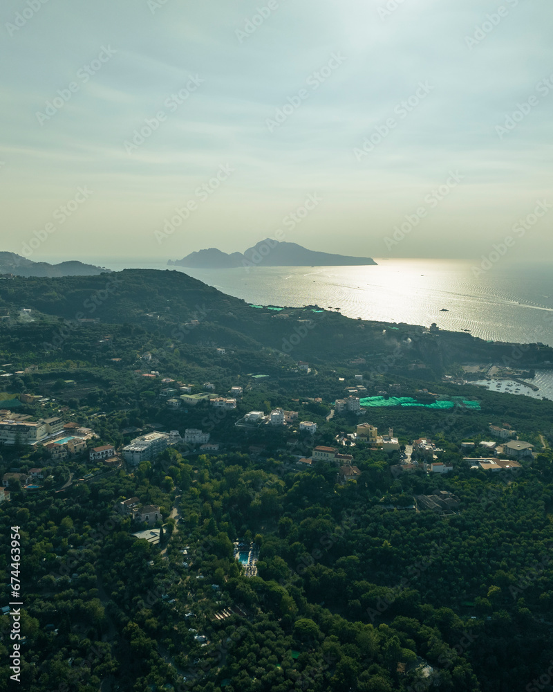 Aerial view of Capri Island at sunset as seen from Sorrento coastline, Campania, Naples, Italy. Aerial view of Capri Island at sunset as seen from Sorrento coastline, Campania, Naples, Italy.
