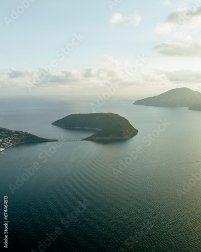 Aerial view of Vivara Island at sunset on Procida Island, view of the Natural reserve with Ischia Island on background, Flegree islands archipelagos, Naples, Campania, Italy. photo