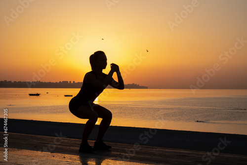the girl is doing sports at sunrise
