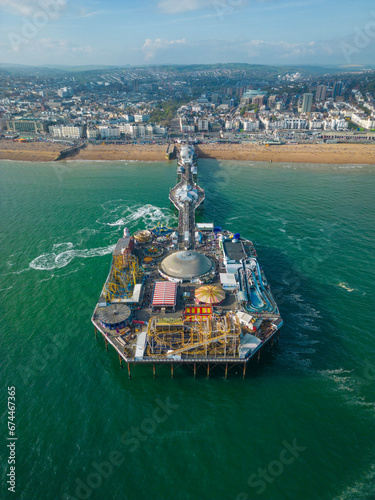 Aerial view of Brighton Palace Pier along the coastline facing the English Channel in Brighton, England, United Kingdom.