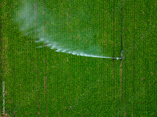Aerial view of a sprinkler in a field in countryside at sunset, Jouy-en-Pithiverais, Loiret, France.
