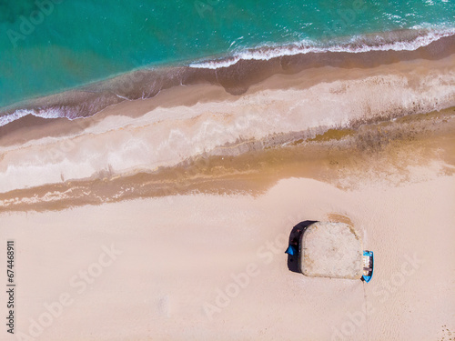 Aerial view of beach Ezerets and blue boat, Ezerets village, city of Shabla, Northern Bulgarian Seaside, Bulgaria. photo