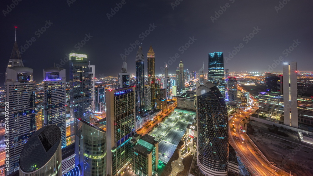 Skyline view of the high-rise buildings on Sheikh Zayed Road in Dubai aerial all night timelapse, UAE. - obrazy, fototapety, plakaty 