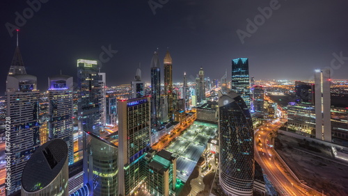 Skyline view of the high-rise buildings on Sheikh Zayed Road in Dubai aerial all night timelapse, UAE. photo